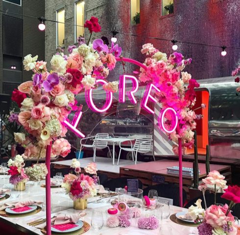FOREO launch dinner beneath a pink neon installation