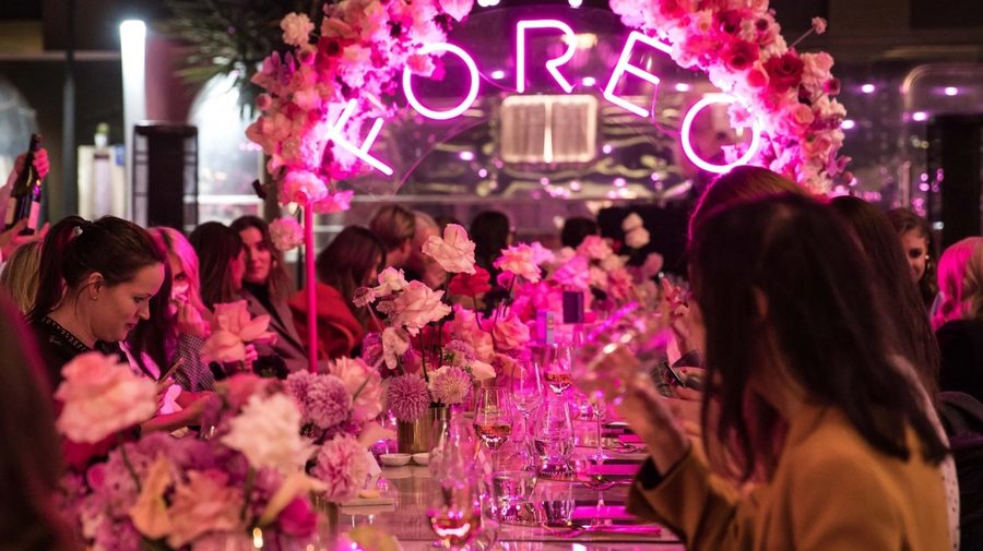 Guests beneath the FOREO neon at a launch party