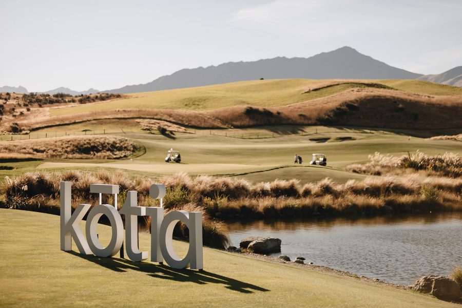 Kotia signage set against a New Zealand landscape